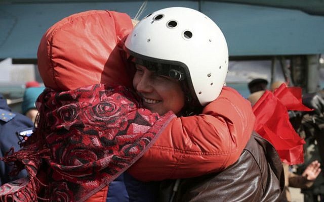 In this photo provided by the Russian Defense Ministry Press Service, a Russian pilot is welcomed after returning from Syria at an airbase near the Russian city Voronezh, Tuesday, March 15, 2016. (Russian Defense Ministry Press Service via AP) 