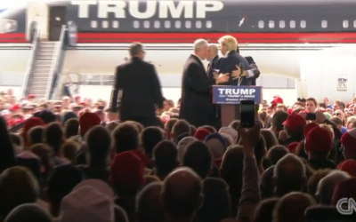 Security guards rush the stage to surround Donald Trump, Dayton, Ohio, March 12, 2016 (CNN screenshot)