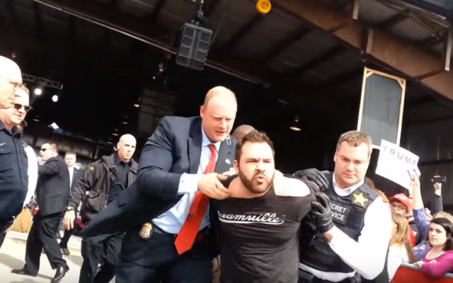 Thomas Dimassimo, who tried to rush the stage at a Donald Trump rally on March 12, 2016, is taken away by security officials (YouTube screenshot)