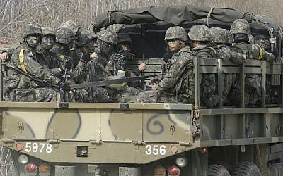 South Korean army soldiers ride on the back of a truck in Paju, near the border with North Korea, Thursday, March 3, 2016. (AP Photo/Ahn Young-joon)