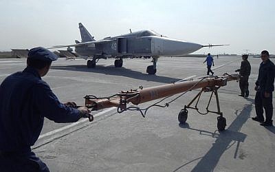 In this photo provided by the Russian Defense Ministry Press Service, Russian military personnel prepare a plane for take off at Hemeimeem air base in Syria, Tuesday, March 15, 2016. (Russian Defense Ministry Press Service via AP)