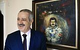 Muhammad Faris, Syria’s first cosmonaut and a former general of the Syrian Air Force, backdropped by a paining of him in a space suit, smiles as he poses for the photographer in Istanbul, Monday, March 7, 2016. (AP Photo/Lefteris Pitarakis)