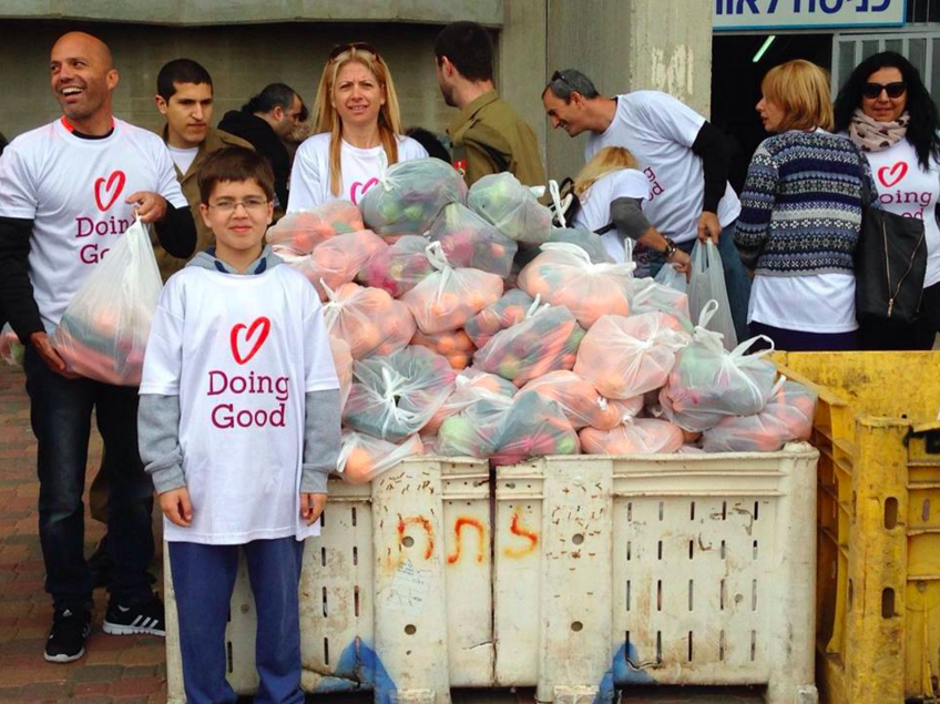 Handing out bagged fruits and vegetables at a bus station for Good Deeds Day (Courtesy Good Deeds Day)