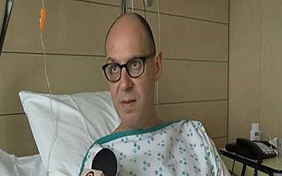 Walter Benjamin speaking to Israel’s Channel 2 News from his hospital bed in Brussels, March 28, 2016. (Screenshot from Channel 2) 