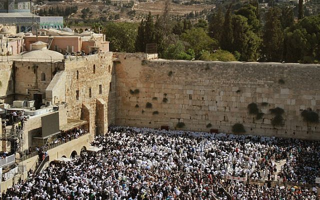 File: Jewish worshipers draped in prayer shawls performing the annual Priestly Blessing during Sukkot at the Western Wall in the Old City of Jerusalem, Sept. 30, 2015. (Gil Cohen/AFP/Getty Images/via JTA)
