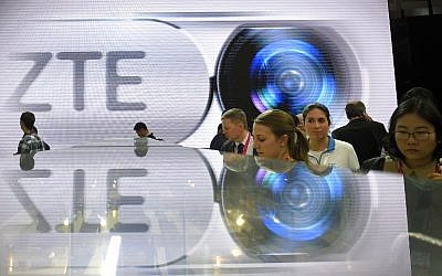 This file photo taken on February 23, 2016 shows visitors testing smart phones at the ZTE's stand during the Mobile World Congress in Barcelona.
The United States said March 7, 2016 it is placing trade restrictions on Chinese telecommunications equipment giant ZTE due to violations of US sanctions on Iran.The Commerce Department said in an order to be officially published on Tuesday that ZTE Corp and related companies set up a scheme to circumvent US sanctions and "illicitly export" controlled items to Iran, violating US laws.
 / AFP / LLUIS GENE