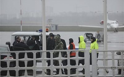 Russian emergency officials and police are seen as they prepare to drive to the area of a plane crash at the Rostov-on-Don airport, about 950 kilometers south of Moscow on March 19, 2016. (AP Photo)