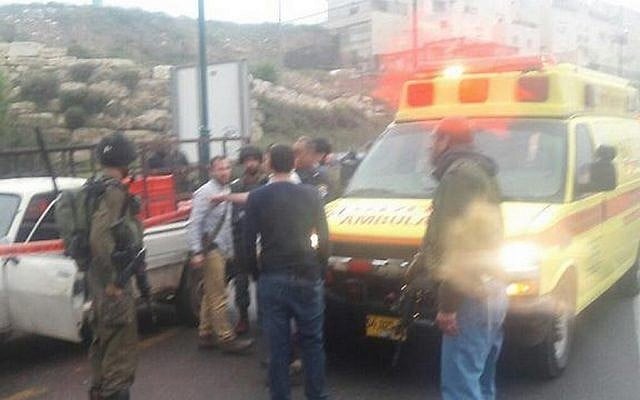 IDF and rescue services at the scene of a Palestinian attack outside Kiryat Arba in the West Bank on Monday, March 14, 2016 (Hatzolah)