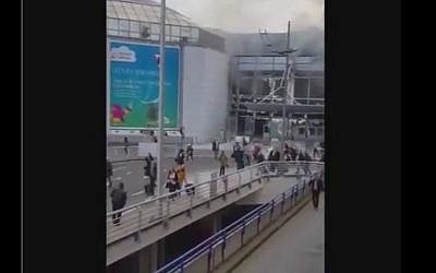 People run out of Brussels airport after twin explosions on March 22, 2016 (screen capture: YouTube)