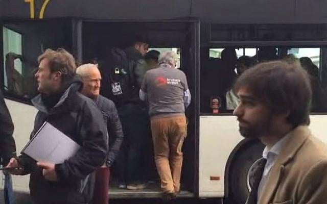 Passengers board buses after they were evacuated from Brussels following twin blasts on March 22, 2016 (screen capture: YouTube)