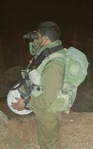 Naftali Dahari, a Yemeni Jew whose family was brought to Israel in a secret rescue operation, peers through a pair of binoculars as part of his service in the IDF's 188th Armored Brigade in this undated photograph. (Courtesy) Naftali Dahari, a Yemeni Jew whose family was brought to Israel in a secret rescue operation, peers through a pair of binoculars as part of his service in the IDF's 188th Armored Brigade in this undated photograph. (Courtesy)