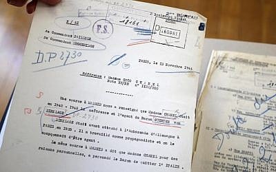 Coco Chanels file with a note written in Paris in November 1944 : "A source in Madrid informed us that Madam Chanel was in 1942-1943 the mistress and agent of Baron Guenter von Dinklage, used to be attache at the German embassy in 1935. He worked as a propagandist and we were suspecting him of being a (German) agent", is displayed with the documents stored for years in the archive rooms of the medieval castle of Vincennes, east of Paris, Wednesday, March 16, 2016. (AP Photo/Francois Mori) Coco Chanels file with a note written in Paris in November 1944 : "A source in Madrid informed us that Madam Chanel was in 1942-1943 the mistress and agent of Baron Guenter von Dinklage, used to be attache at the German embassy in 1935. He worked as a propagandist and we were suspecting him of being a (German) agent", is displayed with the documents stored for years in the archive rooms of the medieval castle of Vincennes, east of Paris, Wednesday, March 16, 2016. (AP Photo/Francois Mori)