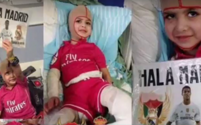 In this screen capture from a YouTube video uploaded on March 16, 2016, Ahmed Dawabsha is seen recovering from his burns in hospital, holding a Real Madrid sign. (YouTube screen capture)