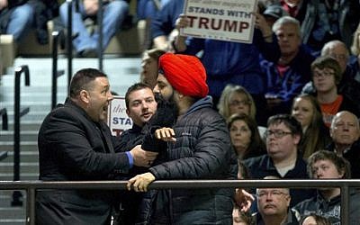 In this Jan. 24, 2016, file photo, a protester, right, is removed after interrupting Republican presidential candidate Donald Trump as he speaks at a rally at Muscatine High School in Muscatine, Iowa. (AP Photo/Andrew Harnik, File) In this Jan. 24, 2016, file photo, a protester, right, is removed after interrupting Republican presidential candidate Donald Trump as he speaks at a rally at Muscatine High School in Muscatine, Iowa. (AP Photo/Andrew Harnik, File)