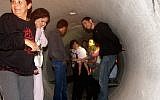 Israeli citizens take cover as a warning siren sounds for possible incoming rockets in Nitzan on November 14, 2012. (Roni Schutzer/Flash90)