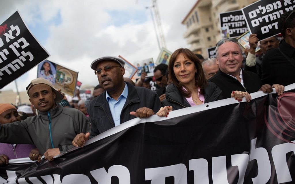 Likud MK Avraham Neguise (second from left). Zionist Union MK Revital Swid (Second from R), and Likud MK David Amsalem (R) during a protest on Ethiopian Israeli immigration in Jerusalem, on March 20, 2016. (Corinna Kern/Flash90 )