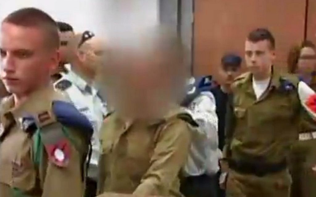 The IDF soldier who shot a disarmed Palestinian attacker in the head in Hebron appears in the Qastina military court on March 31, 2016. (screen capture: Channel 2)