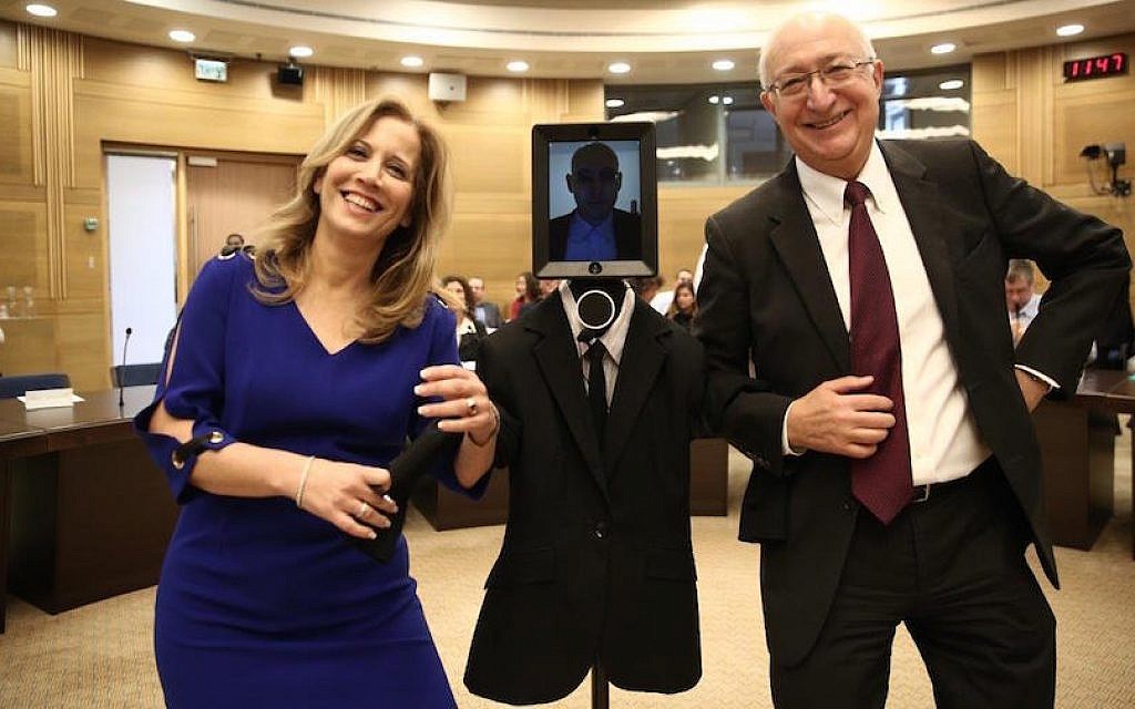 MKs Aliza Lavie (L) and Manuel Trachtenberg pose with the robot “visitor” at a session of the Knesset Science and Technology Committee, February 2, 2016 (Knesset Spokesperson) MKs Aliza Lavie (L) and Manuel Trachtenberg pose with the robot “visitor” at a session of the Knesset Science and Technology Committee, February 2, 2016 (Knesset Spokesperson)