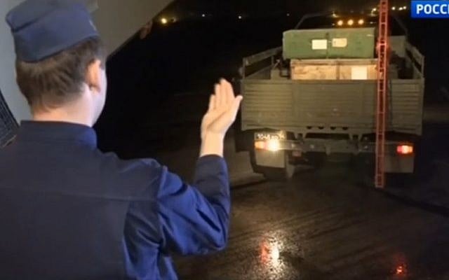Russian soldiers loading equipment onto a plane at a base in Syria, in footage aired on March 15, 2016. (Screen capture: Vesti.ru)