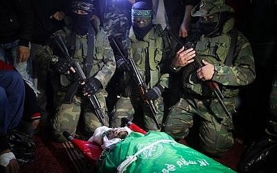 Palestinian members of the Ezzedine al-Qassam Brigades, seen near the body of Marwan Maarouf, 27, during his funeral in Khan Yunis in the southern Gaza Strip, on February 9, 2016. Maarouf was killed when a tunnel collapsed in the Gaza Strip. Photo by Abed Rahim Khatib/Flash90.