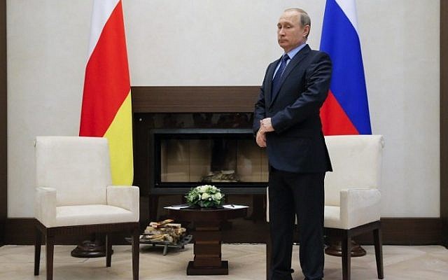 Russian President Vladimir Putin adjusts his jacket before a meeting with the leader of Georgia's breakaway province of South Ossetia at the Novo-Ogaryovo state residence outside Moscow, on March 31, 2016. AFP / POOL / MAXIM SHEMETOV) Russian President Vladimir Putin adjusts his jacket before a meeting with the leader of Georgia's breakaway province of South Ossetia at the Novo-Ogaryovo state residence outside Moscow, on March 31, 2016. AFP / POOL / MAXIM SHEMETOV)
