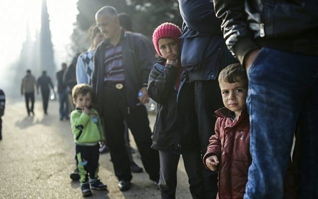 Migrant and refugees wait for food distribution at their makeshift camp in the northern border village of Idomeni, on April 5, 2016. (AFP/Bulent Kilic) Migrant and refugees wait for food distribution at their makeshift camp in the northern border village of Idomeni, on April 5, 2016. (AFP/Bulent Kilic)