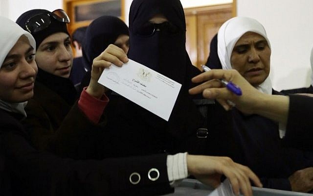 Syrian women vote in the parliamentary elections at a polling station in Damascus on April 13, 2016.
Polls opened in areas of war torn Syria controlled by President Bashar al-Assad, for a vote that will not be recognised by the United Nations and has been dismissed by regime opponents as illegitimate. (AFP PHOTO / LOUAI BESHARA) Syrian women vote in the parliamentary elections at a polling station in Damascus on April 13, 2016.
Polls opened in areas of war torn Syria controlled by President Bashar al-Assad, for a vote that will not be recognised by the United Nations and has been dismissed by regime opponents as illegitimate. (AFP PHOTO / LOUAI BESHARA)