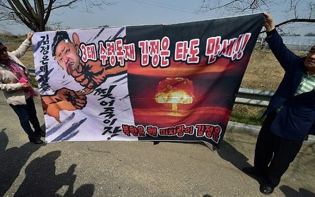 South Korean conservative activists display a banner showing a caricature of North Korean leader Kim Jong-Un as police block the activists attempting to launch anti-North Korea balloons in the border city of Paju on April 15, 2016. (Jung Yeon-Je/AFP) South Korean conservative activists display a banner showing a caricature of North Korean leader Kim Jong-Un as police block the activists attempting to launch anti-North Korea balloons in the border city of Paju on April 15, 2016. (Jung Yeon-Je/AFP)