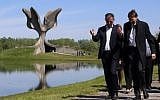 Illustrative: Members of the Jewish community walk in front of a memorial in the shape of a flower in Jasenovac on April 15. 2016. (AFP PHOTO / STRINGER)