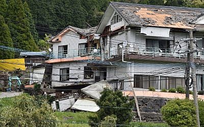 Collapsed houses are seen in Minami Aso village, Kumamoto prefecture on April 16, 2016 after a powerful earthquake hit southern Japan in the early hours. (AFP PHOTO/KAZUHIRO NOGI)
