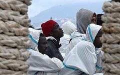 Men waiting to disembark from the Italian Coast Guard vessel "Dattilo" in the port of Messina, Sicily, following a rescue operation of migrants and refugees at sea, February 1, 2016. (AFP/GIOVANNI ISOLINO)