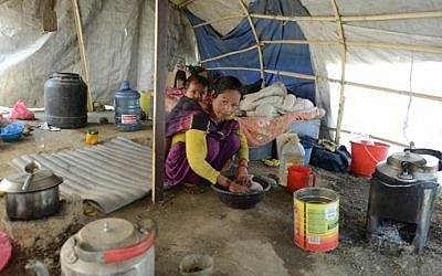 In this photograph taken on April 21, 2016, Nepalese earthquake survivor Menuka Rokaya cares for her child as she speaks with AFP in Ramechhap on the outskirts of Kathmandu. (AFP PHOTO / PRAKASH MATHEMA)