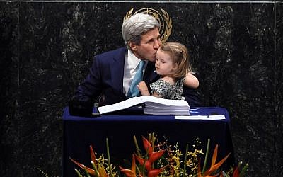 US Secretary of State John Kerry kisses his granddaughter, Isabelle Dobbs-Higginson, after signing during the signature ceremony for the Paris Agreement at the United Nations General Assembly Hall on April 22, 2016 in New York. (AFP PHOTO/JEWEL SAMAD)