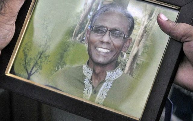 A man holds a portrait of Bangladeshi professor Rezaul Karim Siddique, who was hacked to death by unidentified attackers, in Rajshahi on April 23, 2016.
(Md. Abdullah Iqbal/AFP) A man holds a portrait of Bangladeshi professor Rezaul Karim Siddique, who was hacked to death by unidentified attackers, in Rajshahi on April 23, 2016.
(Md. Abdullah Iqbal/AFP)