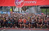 Competitors in the Elite Men's race lead the pack at the start of the 2016 London Marathon in central London on April 24, 2016.  (AFP PHOTO / GLYN KIRK)