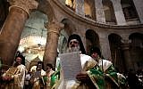 Greek Orthodox priests hold palm branches as they circle the aedicule during the Palm Sunday Easter procession at the Church of the Holy Sepulchre in Jerusalem's Old City on April 24, 2016 (AFP/Gali Tibbon)