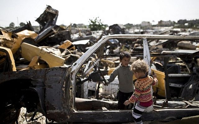Palestinian children play in abandoned vehicles in an impoverished area in the southern Gaza Strip city of Khan Younis, on April 26, 2016. (AFP/Mahmud Hams) Palestinian children play in abandoned vehicles in an impoverished area in the southern Gaza Strip city of Khan Younis, on April 26, 2016. (AFP/Mahmud Hams)