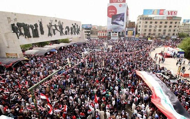 Iraqi supporters of the Sadrist movement hold national flags and shout slogans during a demonstration to press for reforms on April 26, 2016, at Baghdad's Tahrir Square. (AFP PHOTO / HAIDAR MOHAMMED ALI) Iraqi supporters of the Sadrist movement hold national flags and shout slogans during a demonstration to press for reforms on April 26, 2016, at Baghdad's Tahrir Square. (AFP PHOTO / HAIDAR MOHAMMED ALI)
