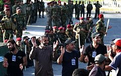 Iraqis shout slogans in front of security forces during a demonstration asking for reforms on April 26, 2016 at an entrance to the heavily fortified Green Zone in Baghdad. (AFP/Haidar Mohammed Ali)