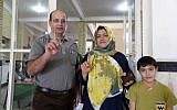 Iranian family members display their ink-stained fingers after casting their ballot to vote in the second round of parliamentary elections at a polling station in the town of Robat Karim, some 40 kms southwest of the capital Tehran, on April 29, 2016. (AFP/Atta Kenare)