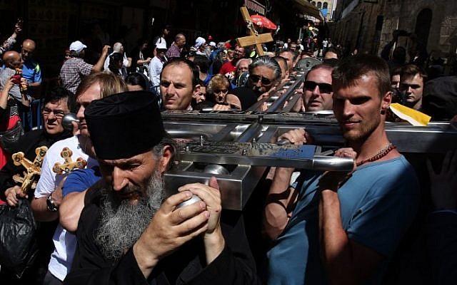 Serbian Orthodox Christian pilgrims carry a large metal cross from Serbia along the Via Dolorosa (Way of Suffering), during the Good Friday procession in Jerusalem's Old City on April 29, 2016. (Gali Tibbon/AFP) Serbian Orthodox Christian pilgrims carry a large metal cross from Serbia along the Via Dolorosa (Way of Suffering), during the Good Friday procession in Jerusalem's Old City on April 29, 2016. (Gali Tibbon/AFP)