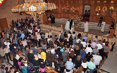 Syrian Greek Orthodox Christians attend a mass during the Good Friday celebrations on April 29, 2016, in the government-controlled side of the northern city of Aleppo. (AFP PHOTO/GEORGE OURFALIAN)