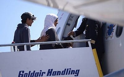 A group of Syrian refugees board a plane with Pope Francis on April 16, 2016 at the airport of Mytilene, in the Greek island of Lesbos. (AFP PHOTO POOL / FILIPPO MONTEFORTE)