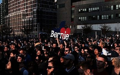People listen as Democratic Presidential candidate Bernie Sanders speaks at a campaign rally in the Queens borough of New York City on the eve of the New York primary, April 18, 2016. (Spencer Platt/Getty Images/AFP)