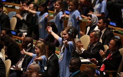 Children from around the world stand in a procession with world leaders and country delegates in the General Assembly Hall at the United Nations Signing Ceremony for the Paris Agreement climate change accord on April 22, 2016. (Spencer Platt/Getty Images/AFP)