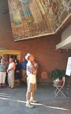 A congregant gazes up at the suspende mural in Ohavi Zedek, 2015 (Courtesy)