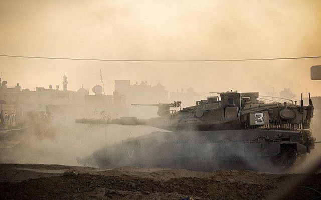 An Israeli tank drives through an undisclosed area of the Gaza Strip during Operation Protective Edge on July 31, 2014. (IDF Spokesperson's Unit) An Israeli tank drives through an undisclosed area of the Gaza Strip during Operation Protective Edge on July 31, 2014. (IDF Spokesperson's Unit)