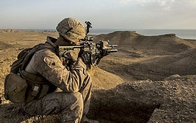 US Marine Corps Sgt. Josh Greathouse scans the area during a perimeter patrol in Al Taqaddum, Iraq, March 21, 2016. (Sgt. Rick Hurtado, Marine Corps/Defense Department)