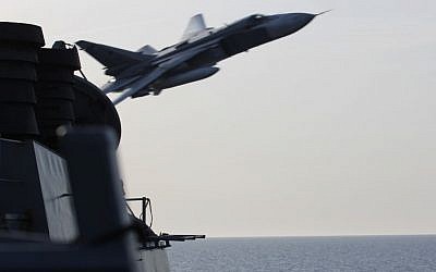 A Russian Sukhoi Su-24 attack aircraft makes a very-low-altitude pass by the USS Donald Cook in international waters in the Baltic Sea, April 12, 2016. (US Navy)