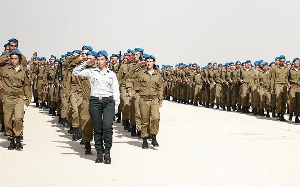 Illustrative: Female Artillery Corps soldiers march and salute during a ceremony on February 25, 2015. (IDF Spokesperson's Unit/Flickr) Illustrative: Female Artillery Corps soldiers march and salute during a ceremony on February 25, 2015. (IDF Spokesperson's Unit/Flickr)